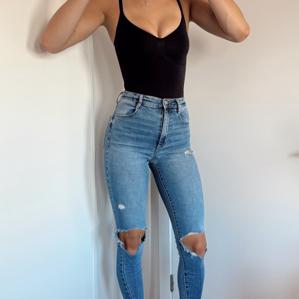 Chic Black Bodysuit with Ripped Blue Jeans